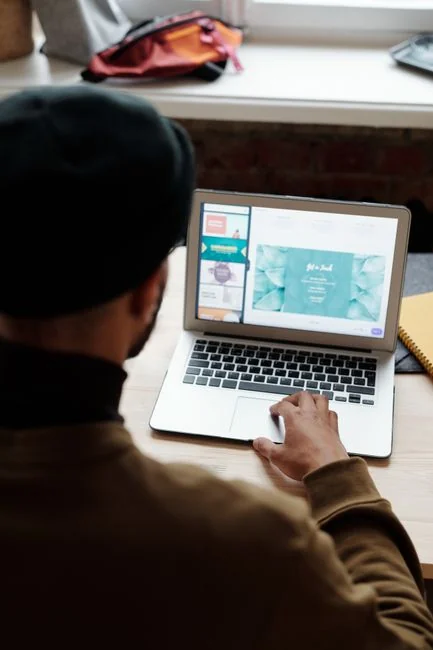 A miniature shopping cart placed on a laptop keyboard symbolizing online shopping and e-commerce.